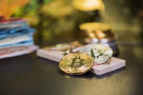 Concept of bitcoin in a  mouse trap. Risks and dangers of investing in the cr Stock Photos