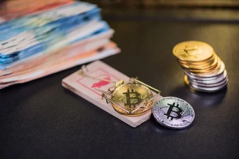 Concept of bitcoin in a  mouse trap. Risks and dangers of investing in the cr Stock Photos