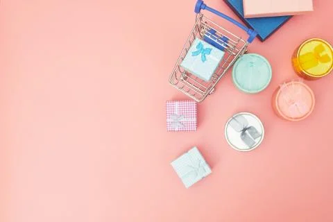 Concept black friday, gift boxes with shopping cart on pink pastel background Stock Photos