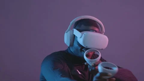 Concept of black man playing in VR headset in red-blue light. It uses futuristic Stock Footage 233612649