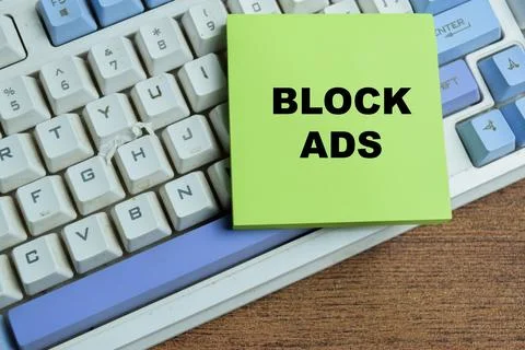 Concept of block ads write on sticky notes isolated on Wooden Table. Stock Photos