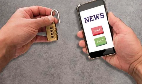 Concept of blocking the spread of false news. Two hands. One holds a phone wi Stock Photos