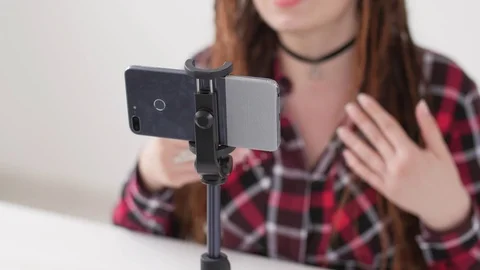 Concept of blogging and video broadcasts. Young female blogger recording video Stock Footage 107206589