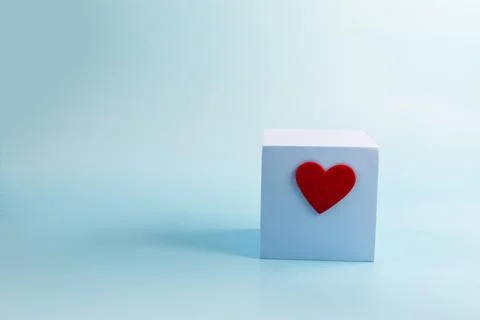 The concept of a blue podium in the form of a cube with a red heart Stock Photos