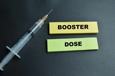 Concept of booster dose write on sticky notes isolated on table. Stock Photos