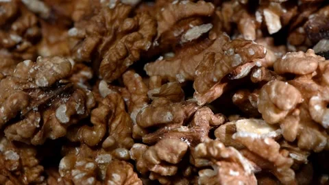 Concept of brain food and intellect: rotating walnut kernels resembling human Stock Footage 325119228