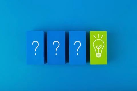 Concept of brainstorming, creativity and fresh ideas. Blue blocks with questions Stock Photos