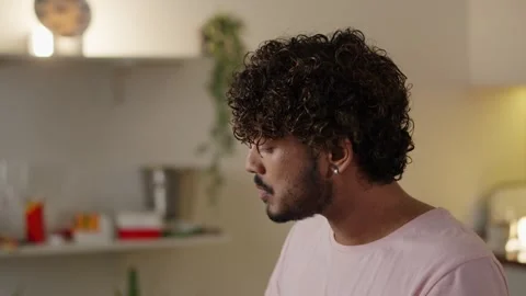 Concept of breakfast. Young guy eating tasty toast and drinking a cup coffee Video stock 254855364