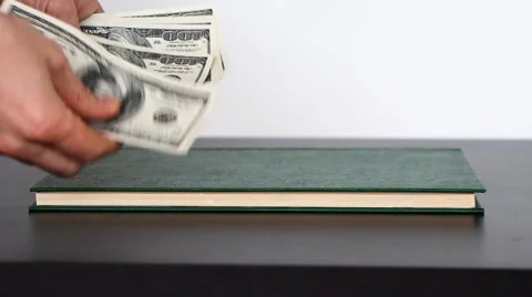 Concept of bribery, corruption and fraud. Hide a bribe in a book. Stock-Footage 60624995