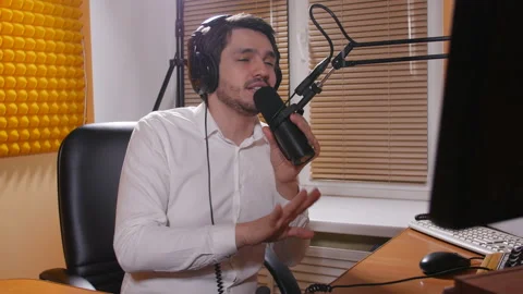 Concept of broadcasting and live broadcasts. Young Male radio broadcaster Stock Footage 100214038