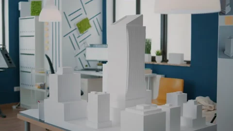 Concept of building model and construction design on table in empty workplace Vídeos de archivo 166419839