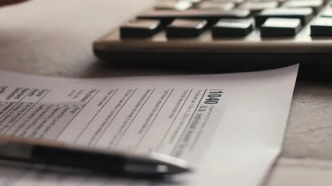 Concept calculation and payment of taxes of a US citizen, a woman's hand co.. Stock Footage 282792979