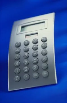 Concept, calculator on blue background Stock Photos