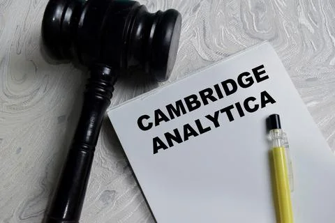 Concept of Cambridge Analytica write on book isolated on Wooden Table. Stock Photos