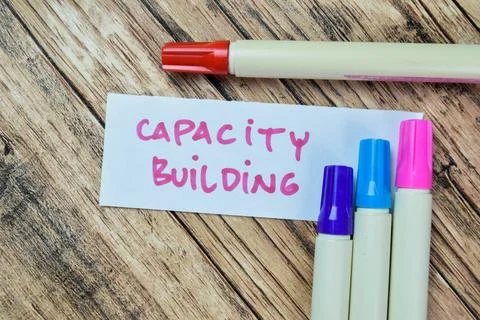 Concept of Capacity Building write on sticky notes isolated on Wooden Table. Fotos de archivo