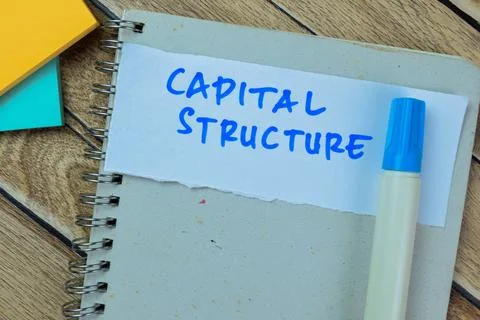 Concept of Capital Structure write on sticky notes isolated on Wooden Table. Fotos de archivo
