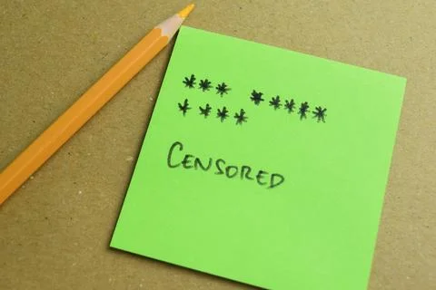 Concept of Censored write on sticky notes isolated on Wooden Table. Stock Photos