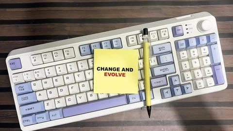 Concept of Change and Evolve write on sticky notes isolated on Wooden Table. Stock Photos