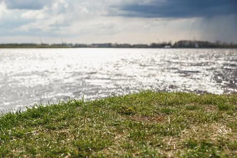 The concept of changeable cloudy windy and rainy weather luscious green grass on Stock Photos