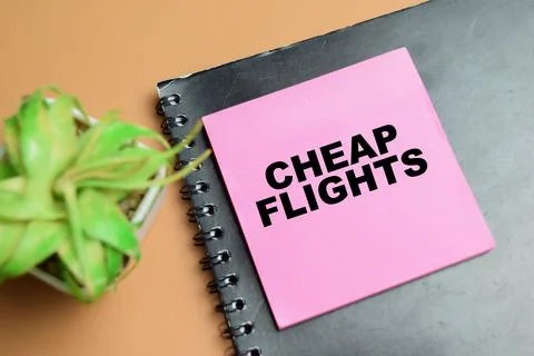 Concept of cheap flights write on sticky notes isolated on table. Stock Photos