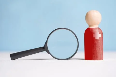 The concept of checking, analyzing the abstract doctor. A wooden figurine in  Stock Photos