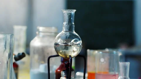 Concept of chemistry experiments in the laboratory boiling chemical liquid on a Stock Footage 153092298