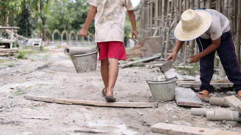 The concept of child labor, Poor children are forced to work in constructio.. Video stock 336941623