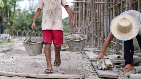 The concept of child labor, Poor children are forced to work in constructio.. Stock Footage 336941695