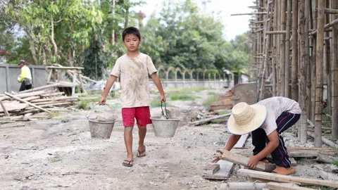 The concept of child labor, Poor children are forced to work in constructio.. Stock Footage 336941778