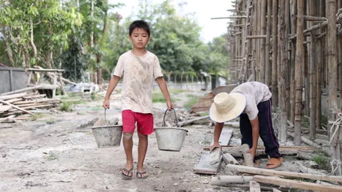 The concept of child labor, Poor children are forced to work in constructio.. Video stock 336941780
