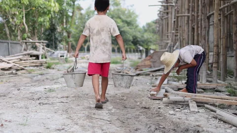 The concept of child labor, Poor children are forced to work in constructio.. Video stock 336941850