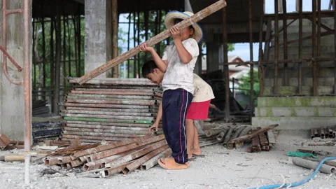 The concept of child labor, Poor children are forced to work in constructio.. Stock Footage 336942087