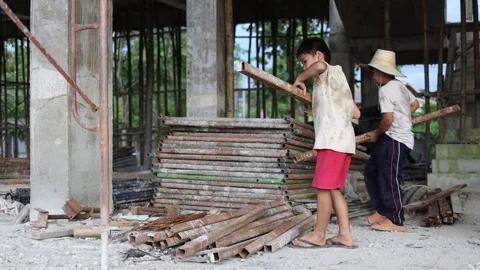 The concept of child labor, Poor children are forced to work in constructio.. Stock Footage 336942177