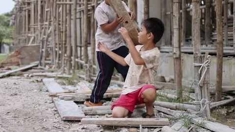 The concept of child labor, Poor children are forced to work in constructio.. Video stock 336942192