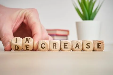 The concept of choice increase and decrease on wooden cubes is turned over by 스톡 사진