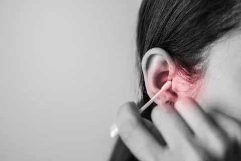 Concept of cleaning in the ear hole. Stock Photos