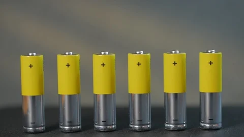 The concept of a close-up of seven AA batteries, male finger, tilt the battery. Stock Footage 123687771