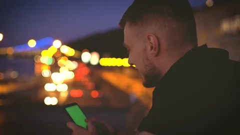 Concept closeup portrait of young man using his smartphone with greenscreen Stock Footage 117629358