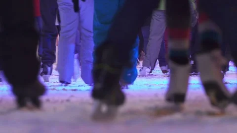 Concept Closeup Skate. Crowd at Night City Skating Rink. Pedestal and Blur Stock-Footage 70464468