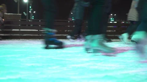 Concept Closeup Winter Sport. Crowd at Night City Skating Rink Pedestal and Blur Stock Footage 70528701