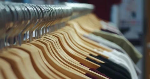 The concept of clothes on hanger. Close-up of colored clothes on hangers in a Stock Footage 251022908