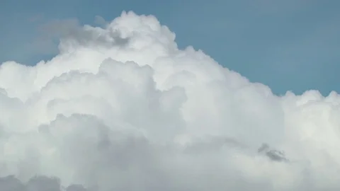 Concept clouds like mountains. White fluffy cottony clouds moving through blue Stock Footage 80068547