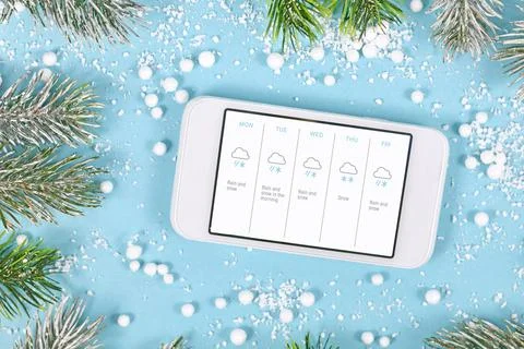 Concept for cold winter temperatures with snow showing mobile phone with Stock Photos