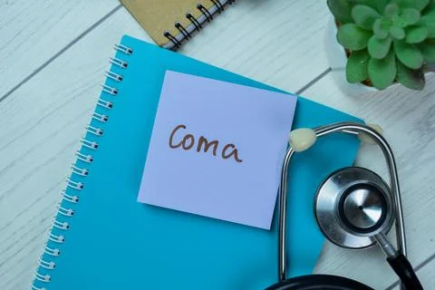 Concept of Coma write on sticky notes with stethoscope Stock Photos