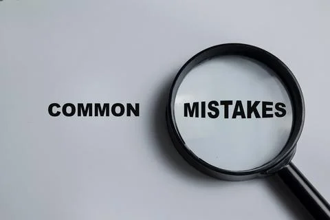 Concept of common mistakes write on book isolated on Wooden Table. Stock Photos