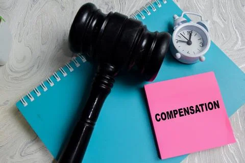 Concept of compensation write on sticky notes isolated on Wooden Table. Stock Photos