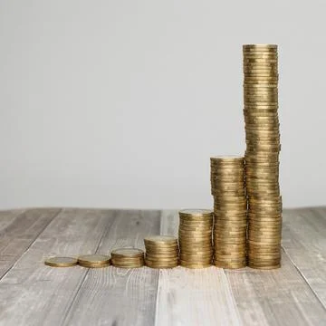 Concept of Compound Interest Effect Demonstrated by Stacked Coins Stock Photos