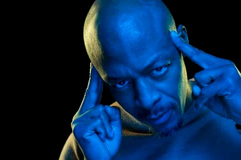 Concept of concentration and mind. Black man touching his temple Stock Photos