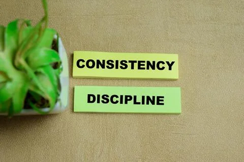Concept of consistency discipline write on sticky notes Stock Photos