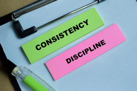 Concept of consistency discipline write on sticky notes Stock Photos